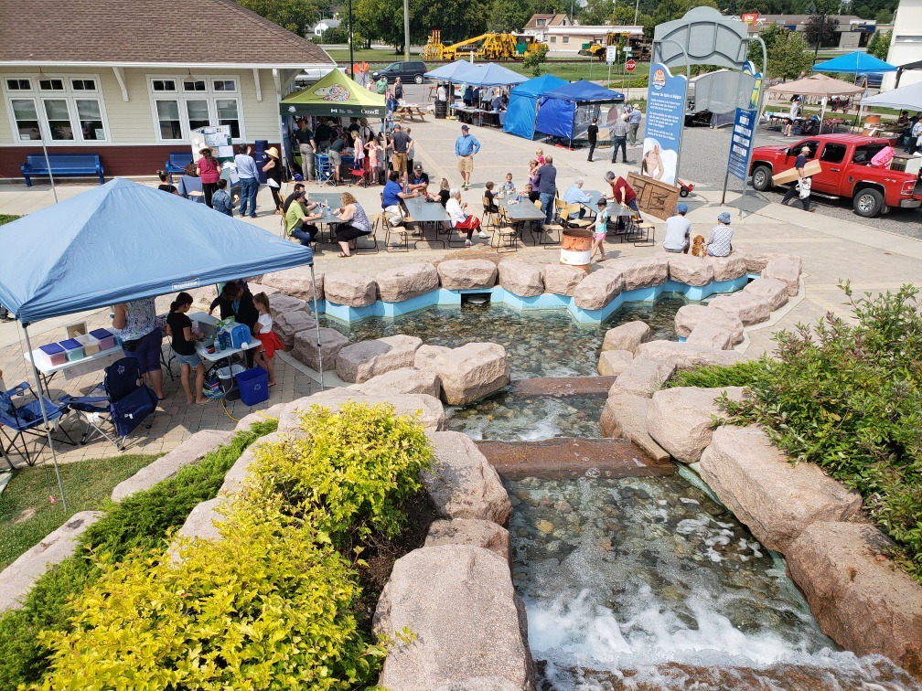 Vendor tents and and visitors in Paddle to the Sea Park, at the Blueberry Blast in Nipigon