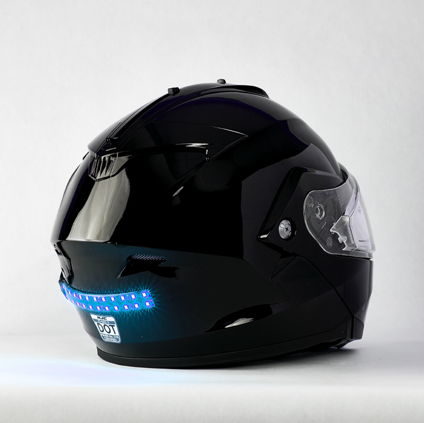 a snowmobile helmet with an illuminated Bite Harder LED light strip across the back.