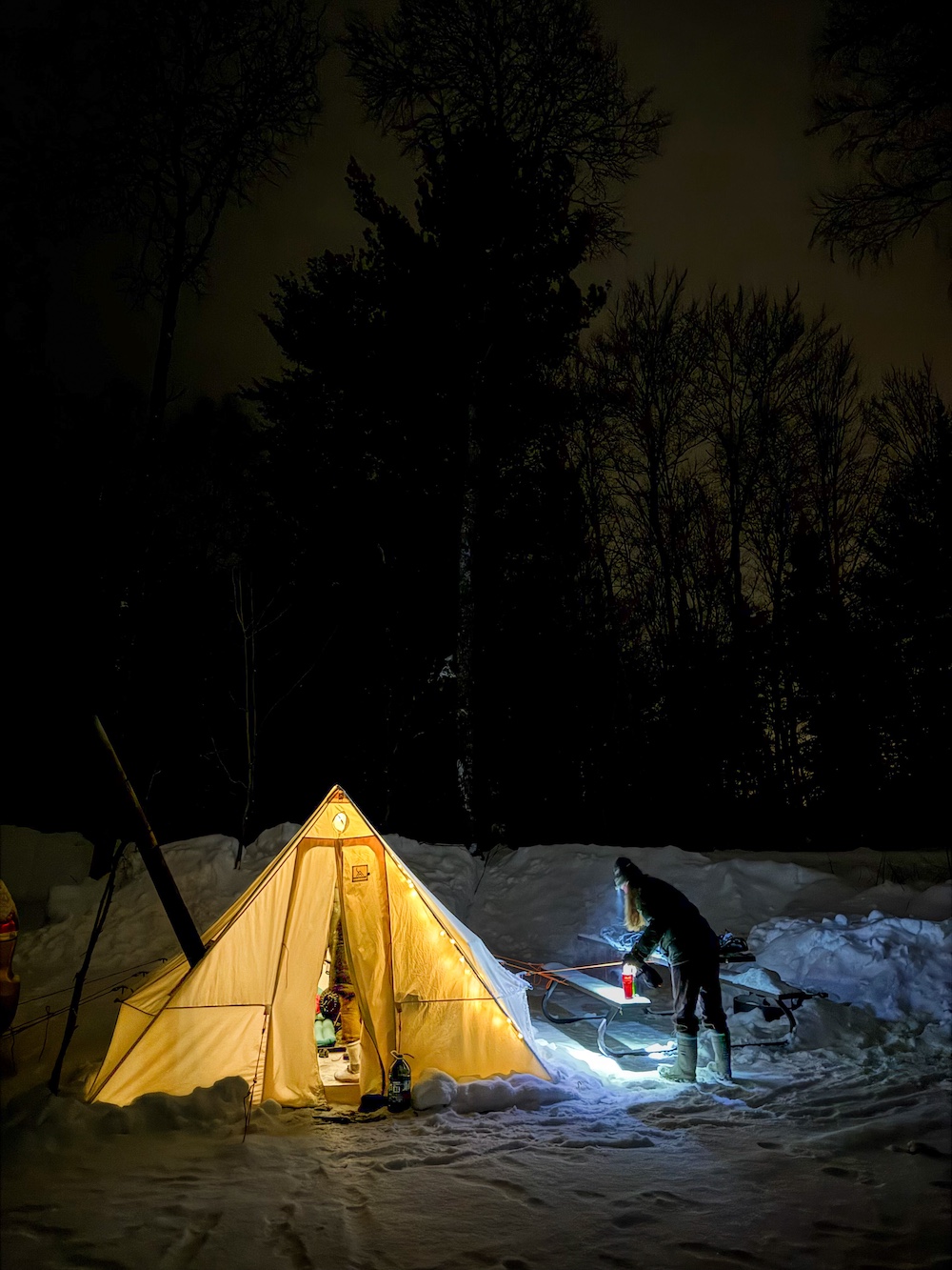 Glowing hot tent at a campground in the winter