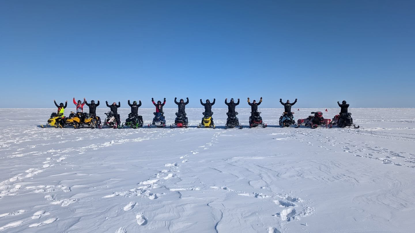 James Baie Snowmobile group in the open arms raised in celebration