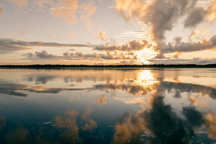 Un coucher de soleil illumine une baie aux eaux cristallines près de Moose Factory.