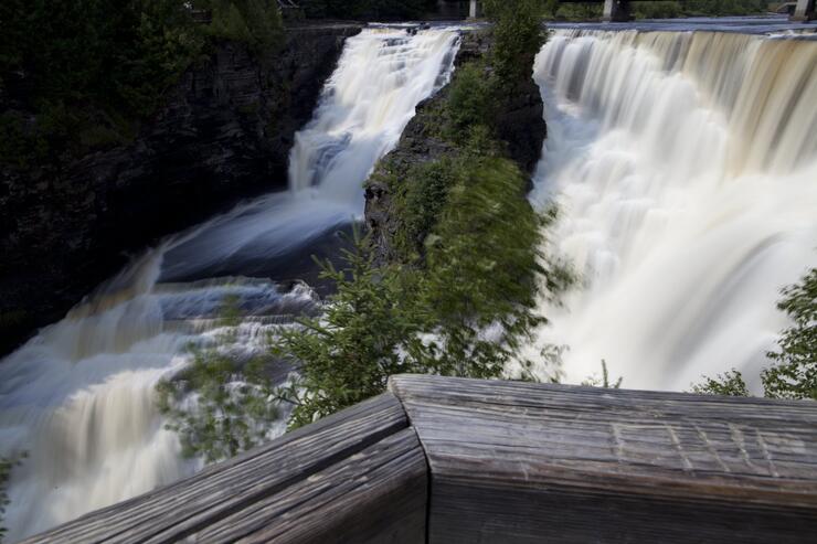 Handrail in front of beautiful waterfall 