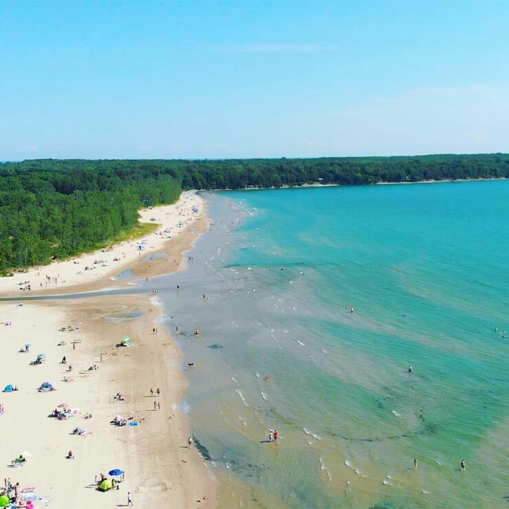 Aerial view of sandy beach and turquoise waters. 