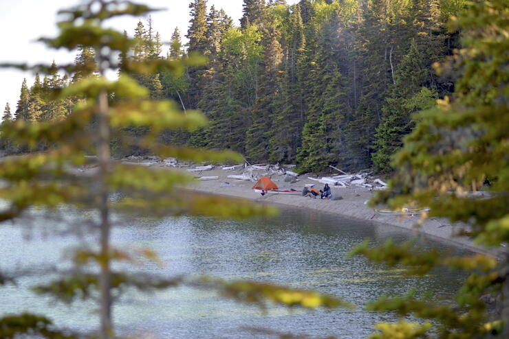 Tents set up on a beach on shore of Lake Superior. 
