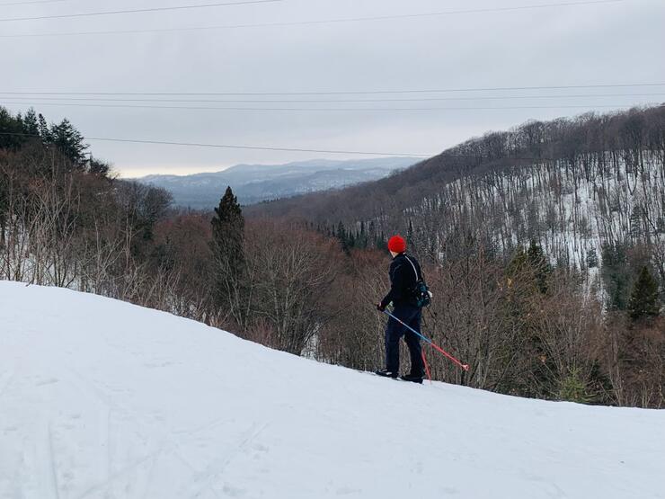 A person gazes out over the snow valley in Goulais River