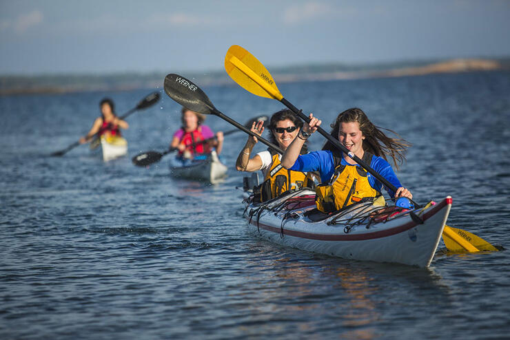 A family group sea kayaking on the Great Lakes