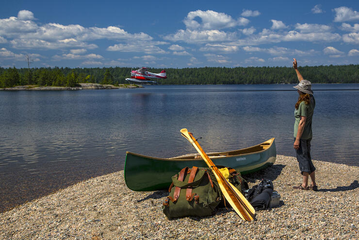 Woman waving a a float plane 
