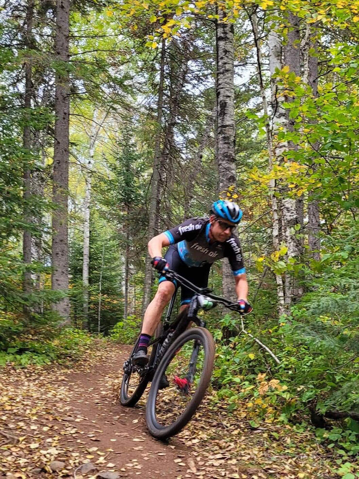 man rides mountain bike on trail near Timmins