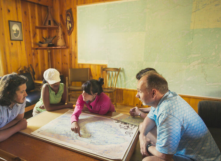 Group of people looking a topo map on a table
