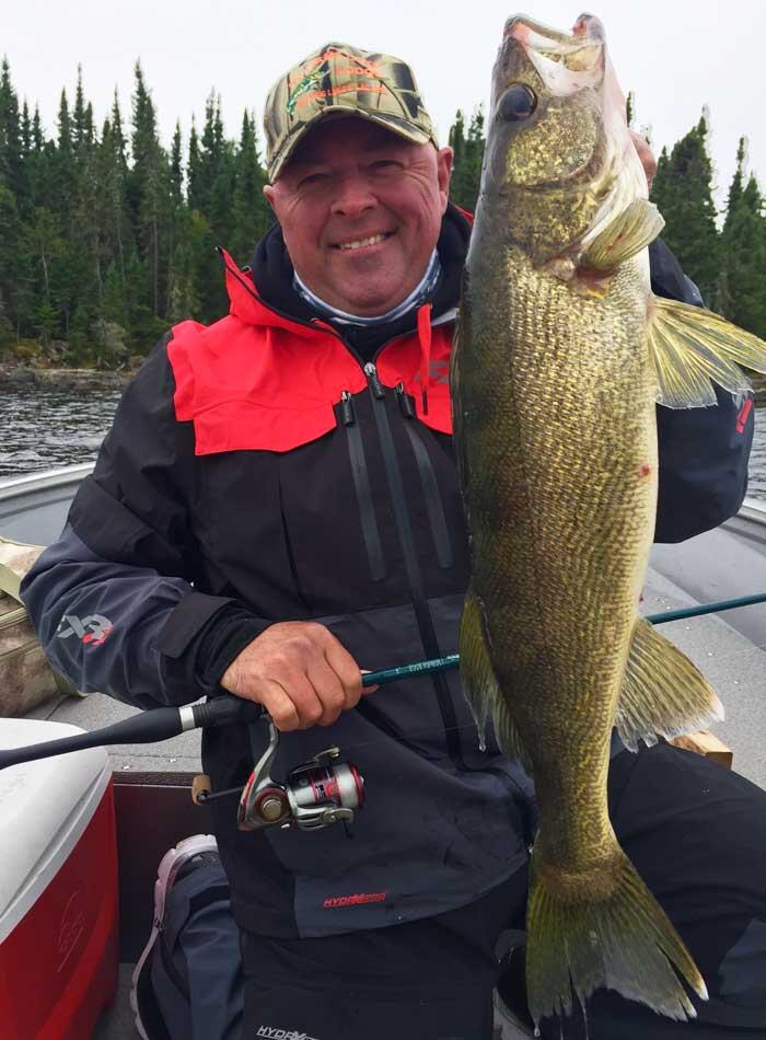 angler holding ontario walleye
