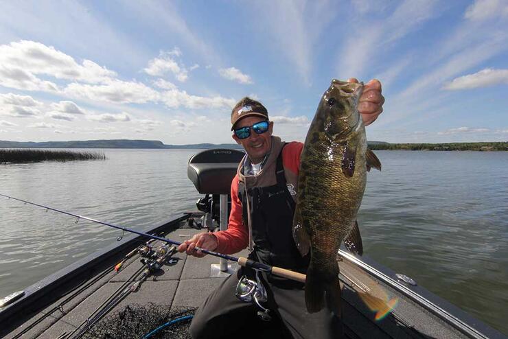 angler holding smallmouth bass