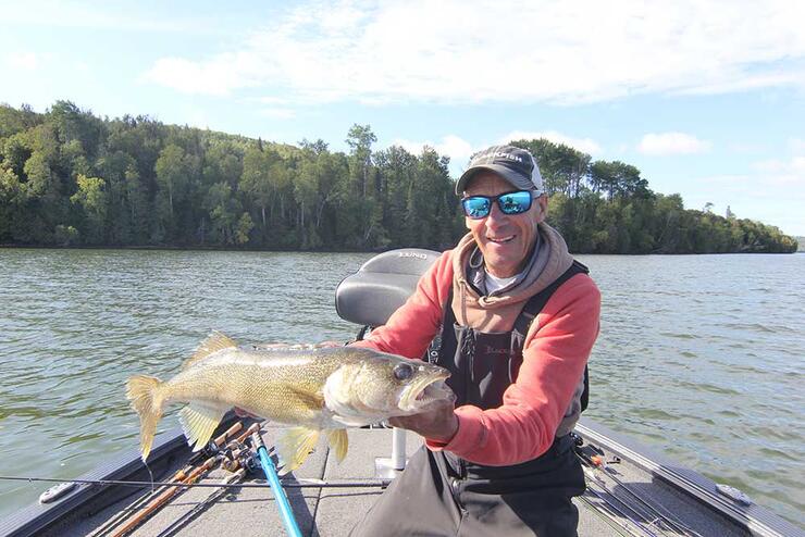 angler holding walleye